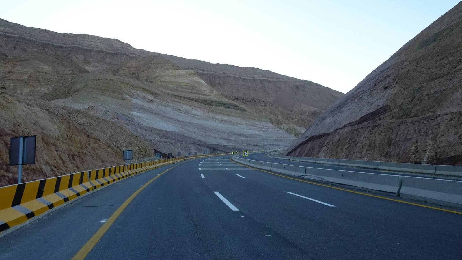 An open road through the mountains