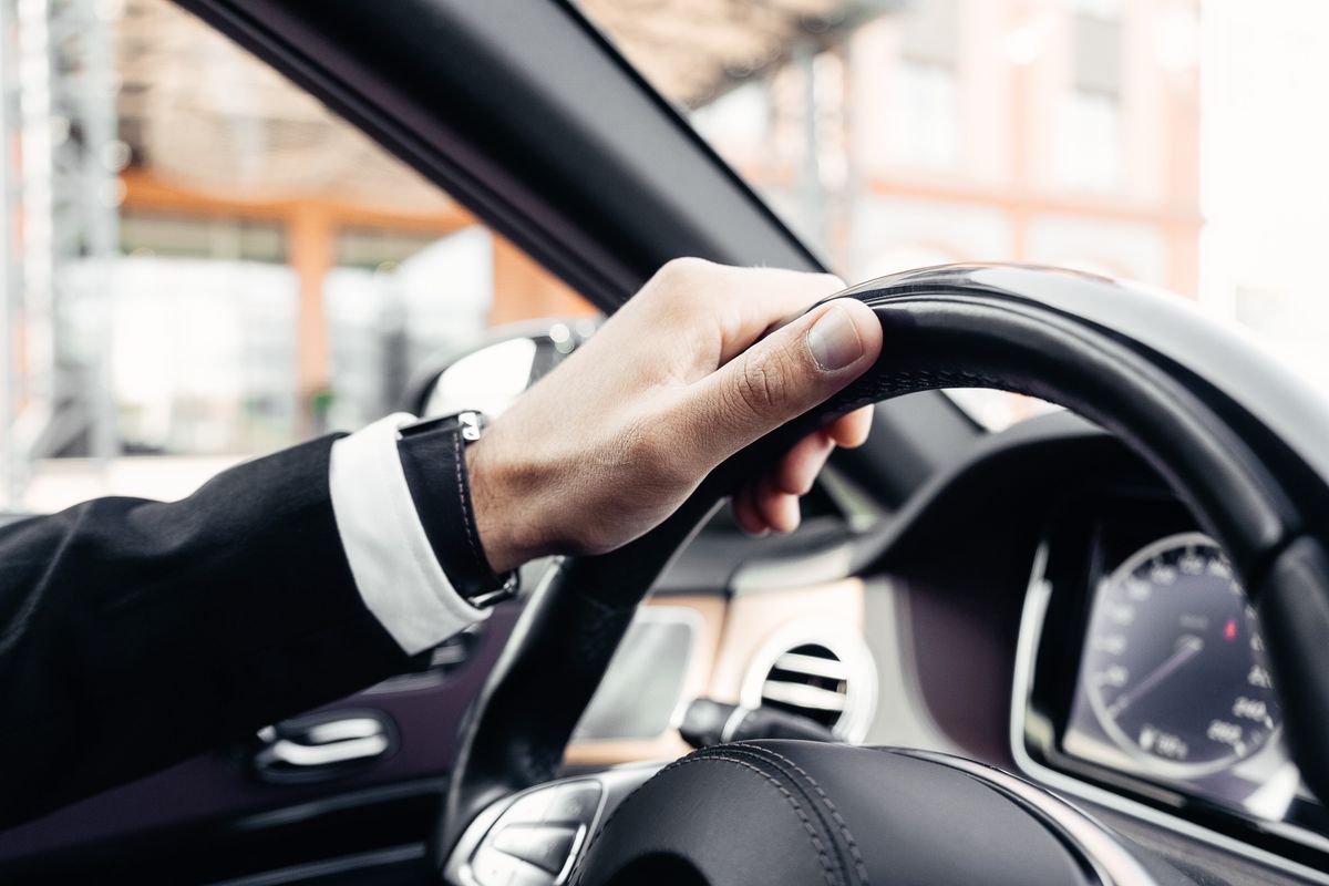 A hand on the steering wheel